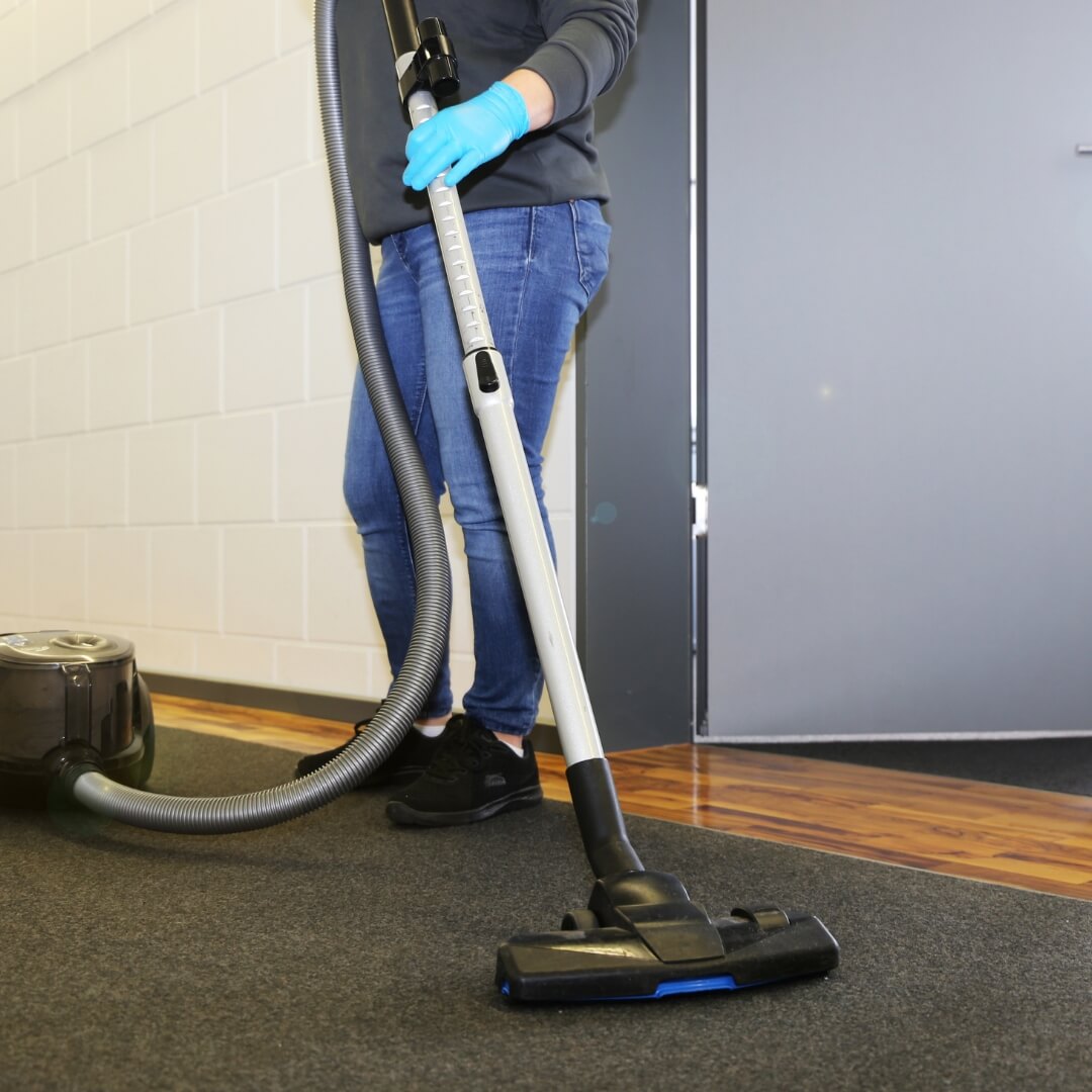 image of a cleaner vacuuming