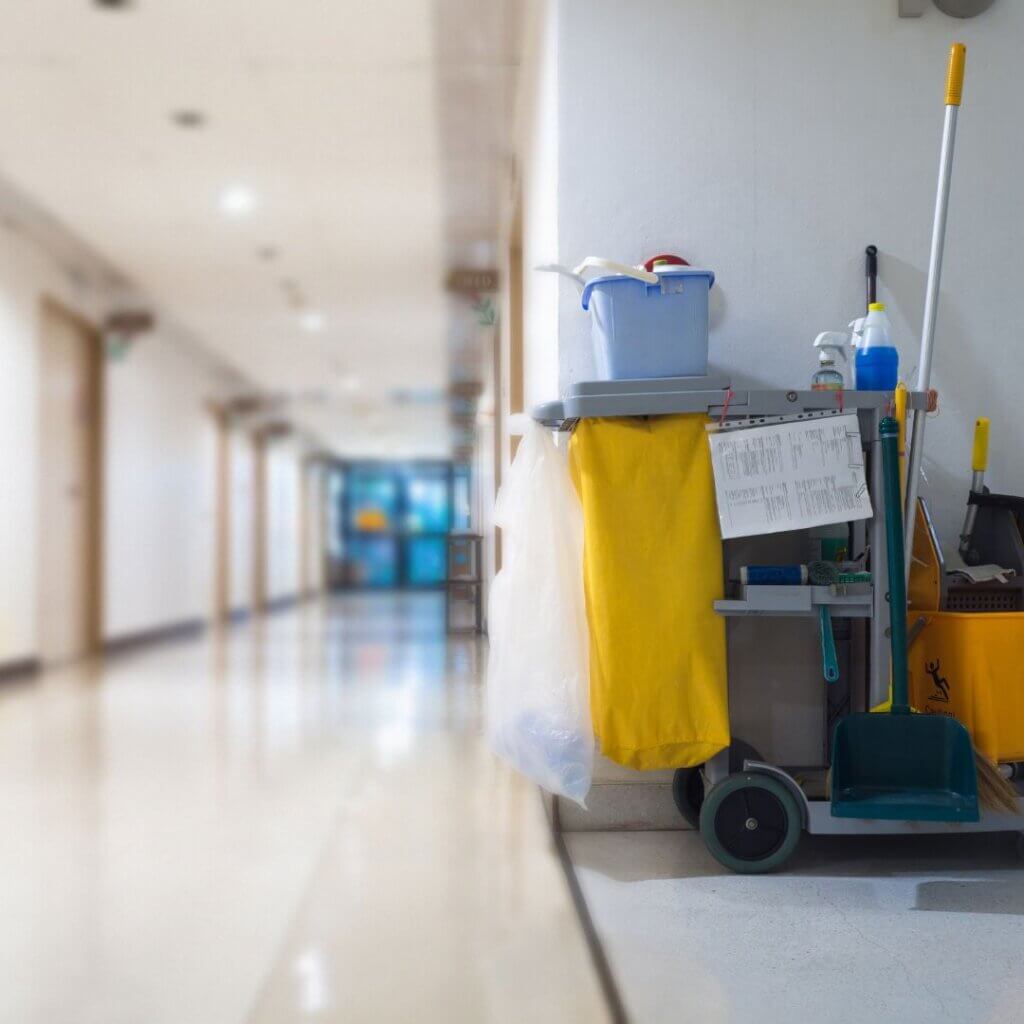 A medical office hallway with a cleaning cart