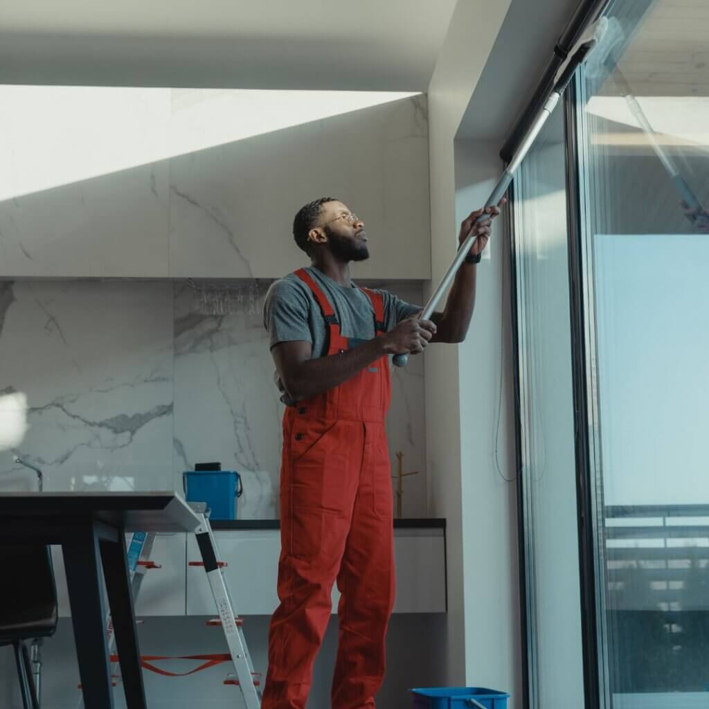 A technician cleaning glass windows