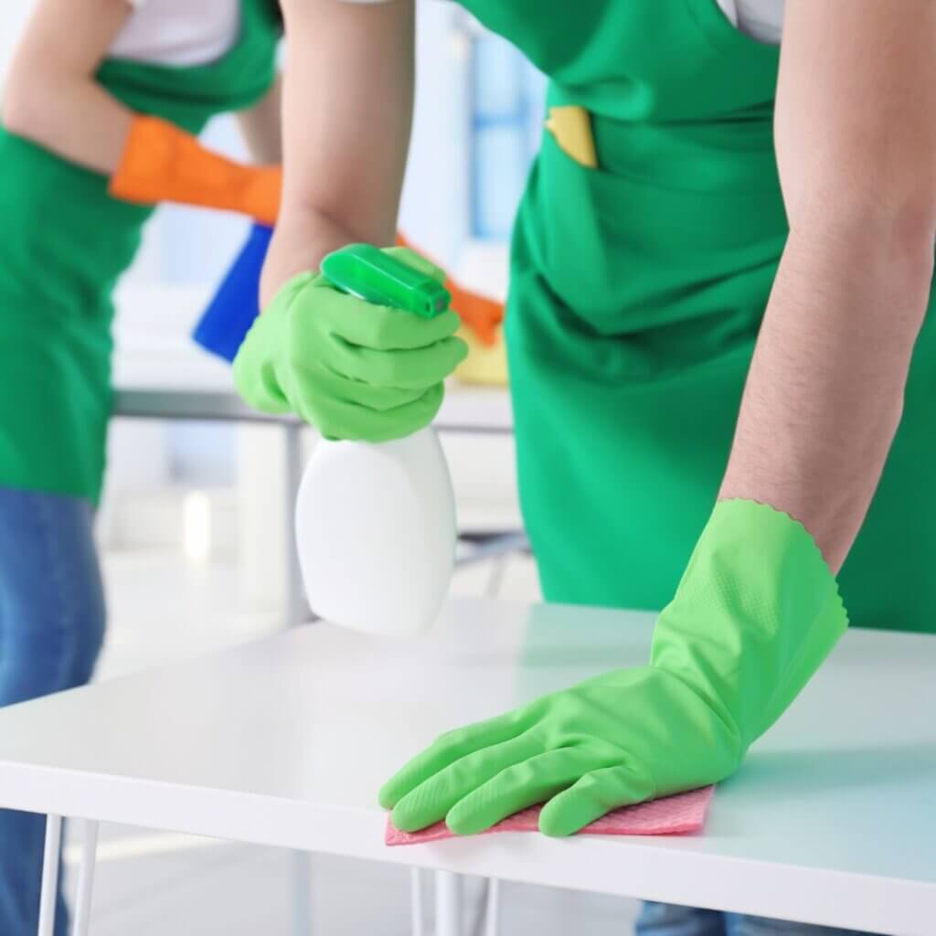 A person scrubbing a table