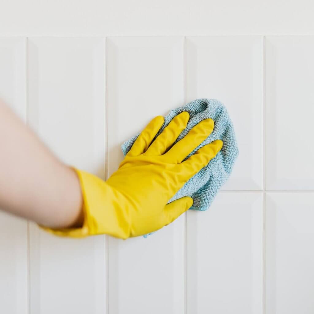 A person cleaning a wall