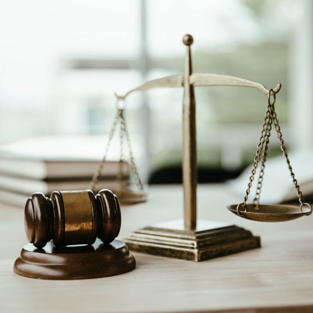 A judge gavel next to a scale