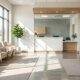 A bright, modern, and empty medical office waiting area filled with natural sunlight.