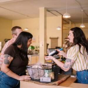 A store employee and customers.